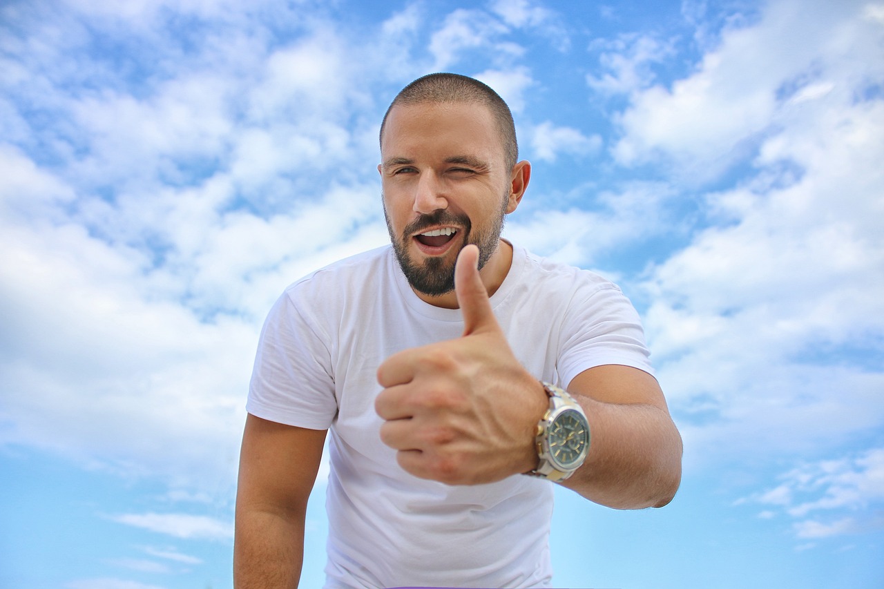 young man, blue sky, thumbs up